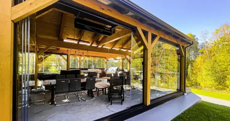 Pivoting glass panels stack at the side to open the sheltered patio to the yard.