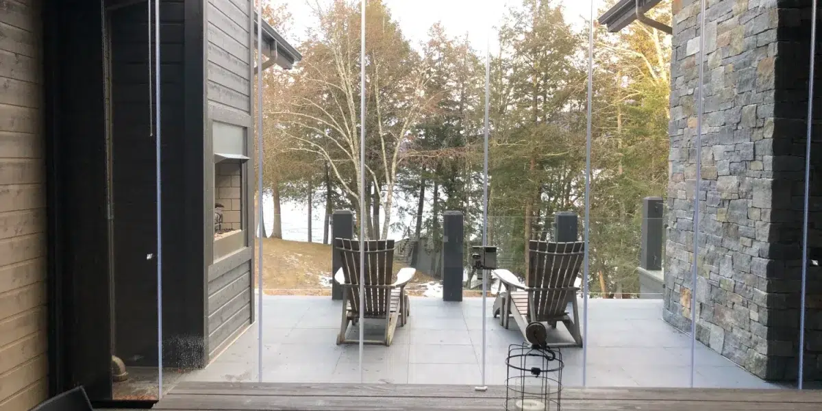 Slim glass panels maintain a clear view when the outdoor space is closed to the weather.