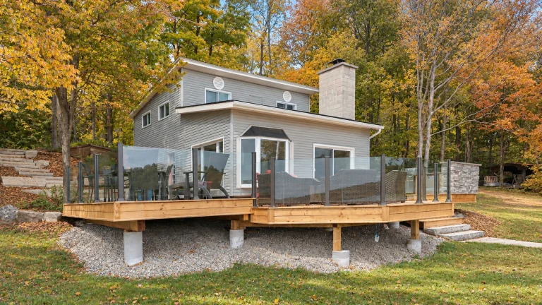 Enjoy your deck more comfortably this fall with a topless glass railing that helps reduce wind exposure without blocking the view.