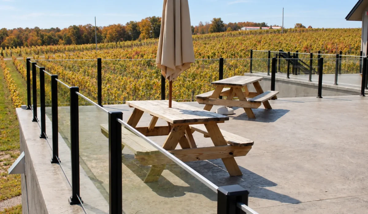 Enjoy your deck more comfortably this fall with a topless glass railing that helps reduce wind exposure without blocking the view.