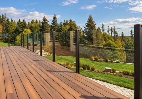 Enjoy your deck more comfortably this fall with a topless glass railing that helps reduce wind exposure without blocking the view.