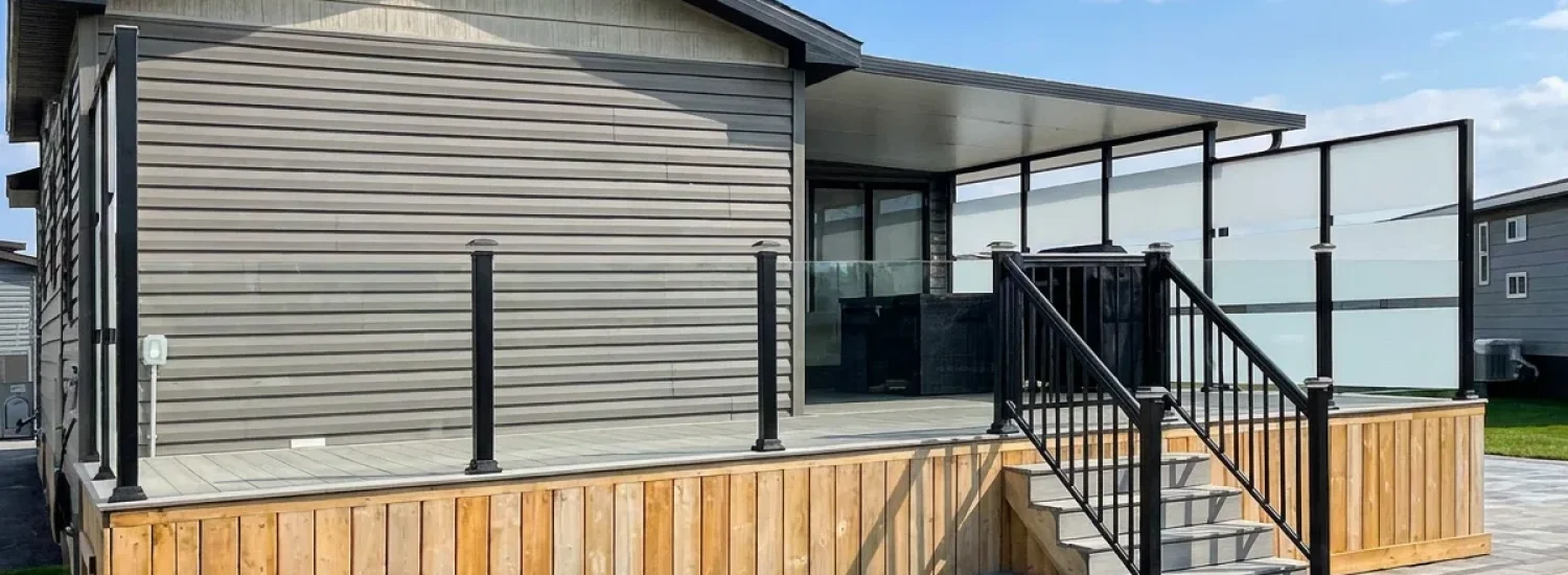 Topless glass railing on a covered residential deck with privacy screens